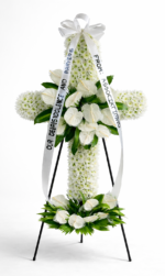 White funeral cross flowers arranged as a standing tribute