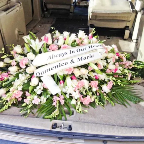 Coffin spray funeral flower arrangement with ribbon message in Manila