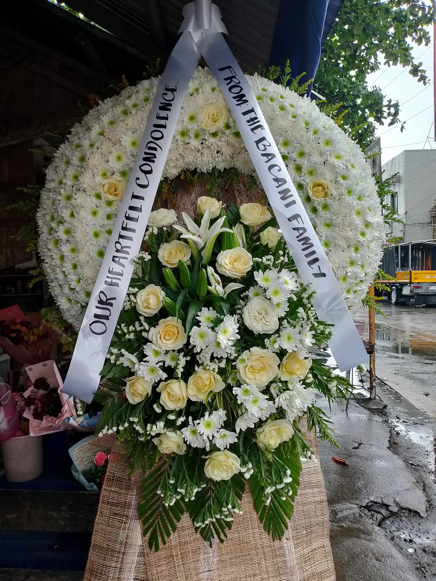 Funeral flower wreath with ribbon message in Manila