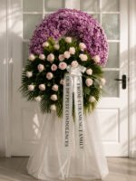 Held in Tender Memory - Purple Funeral Wreath with Pink Roses
